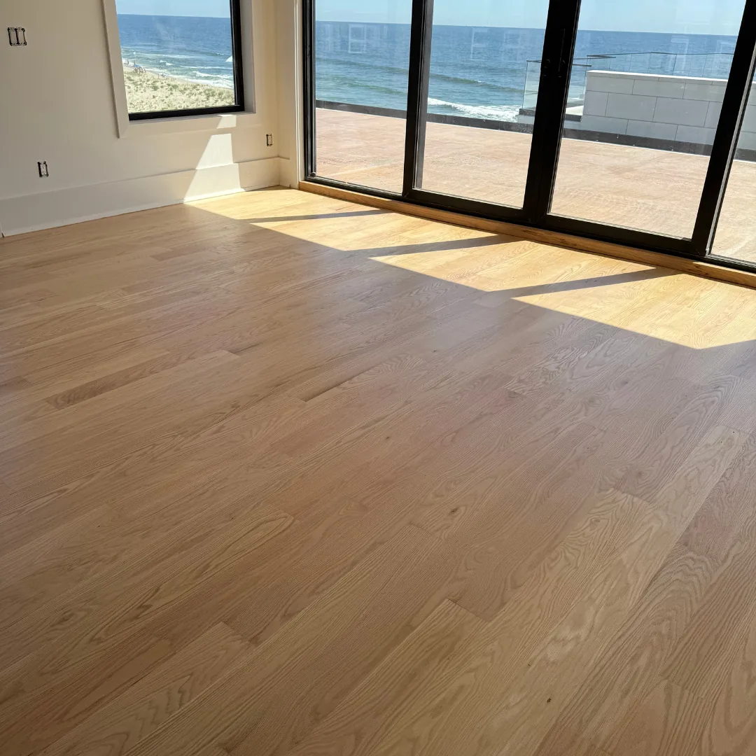Newly installed hardwood flooring in a room with ocean view