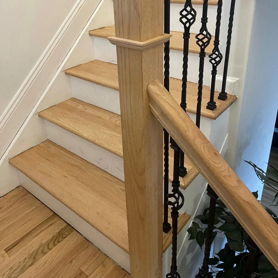 White oak stair treads with wrought iron balusters and wood handrail