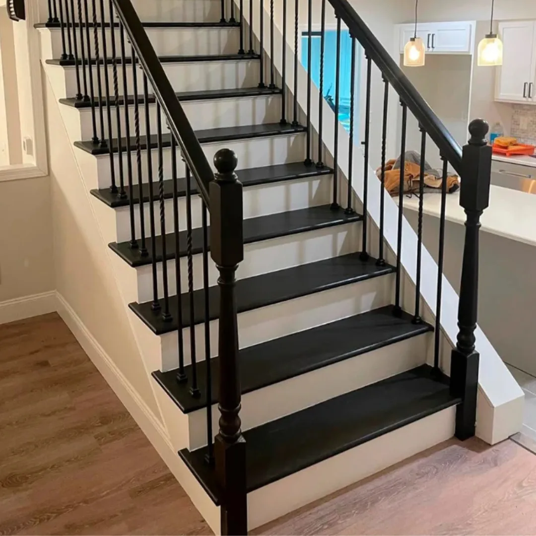 Black and white modern staircase with wood flooring.