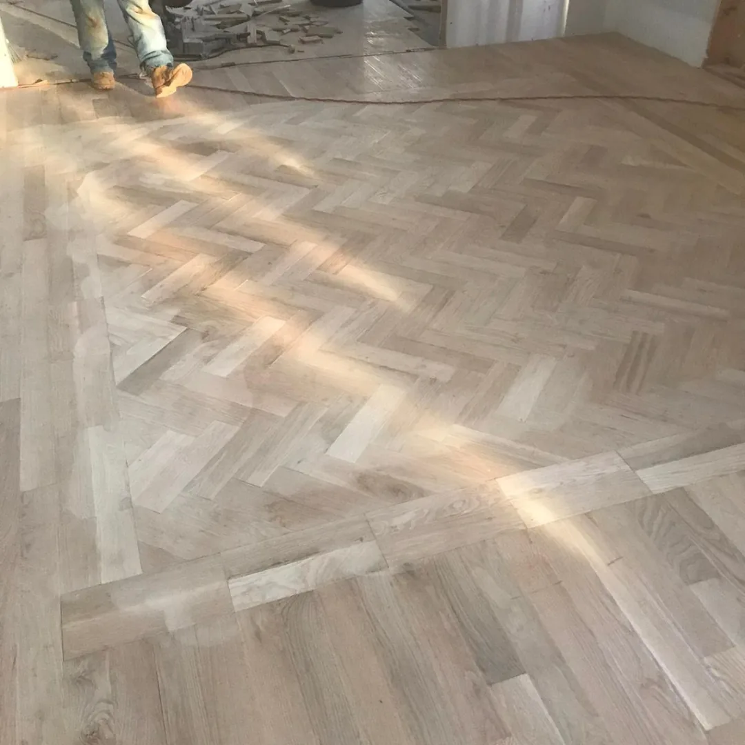 Herringbone hardwood floor installation in progress