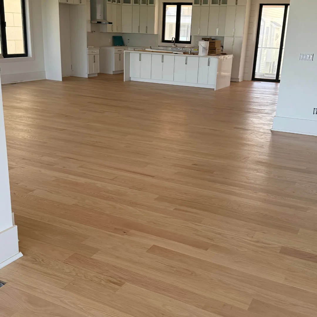 Newly installed hardwood floors in modern kitchen.