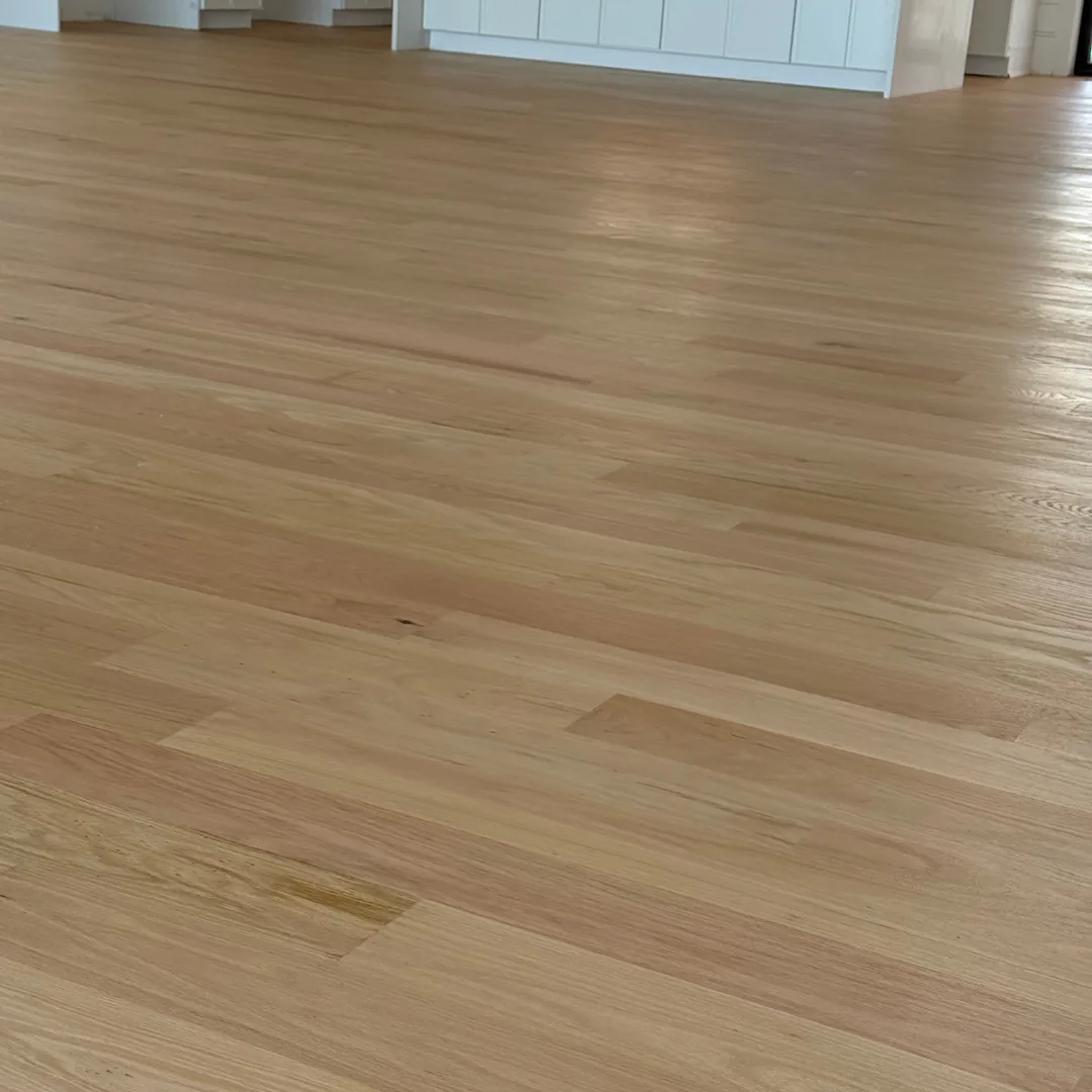 Newly installed light hardwood flooring in home.