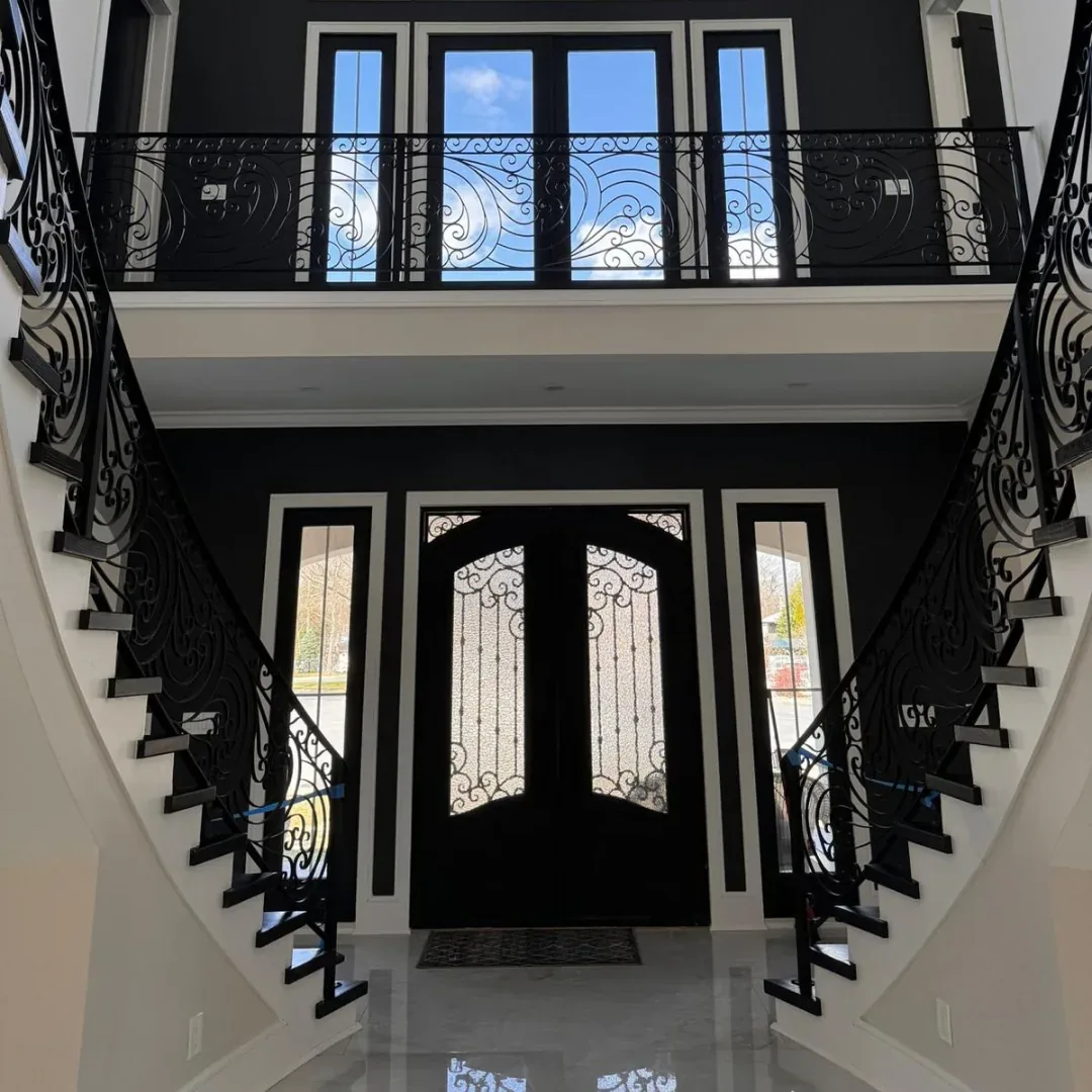 Elegant entryway with black ornate railings.